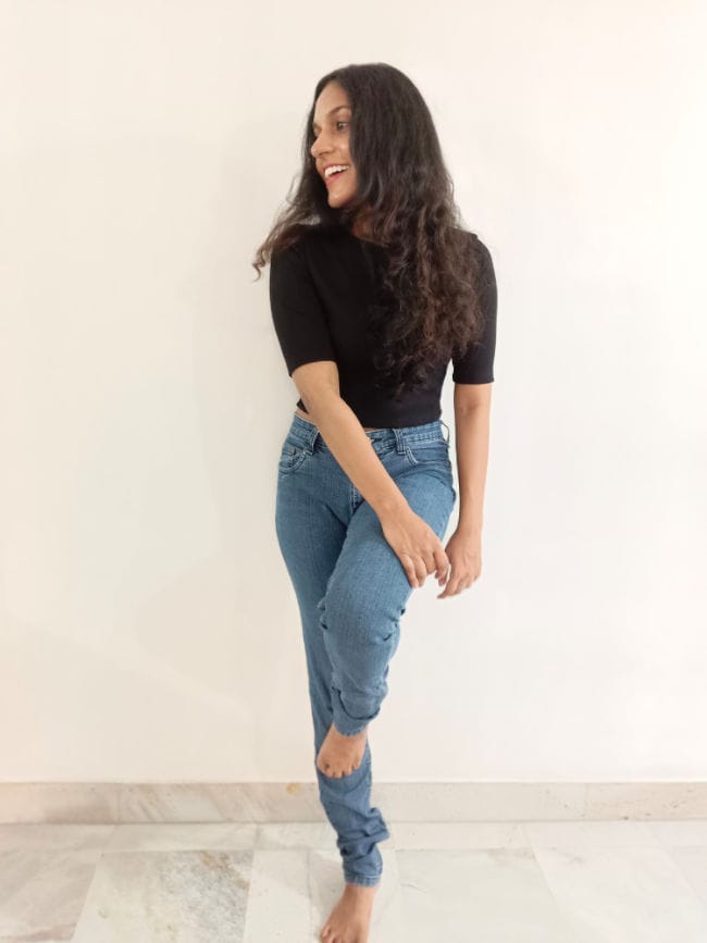 Anjana posing against a wall