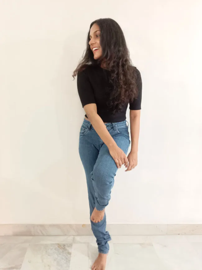 Anjana posing against a wall